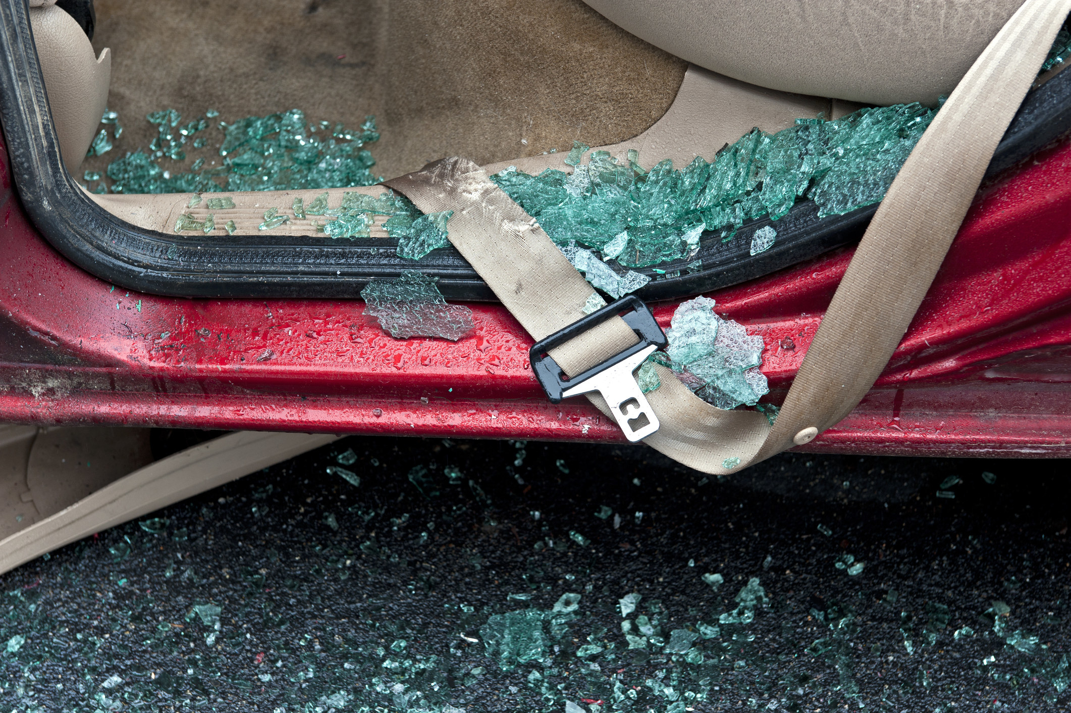 seatbelt surrounded by broken glass