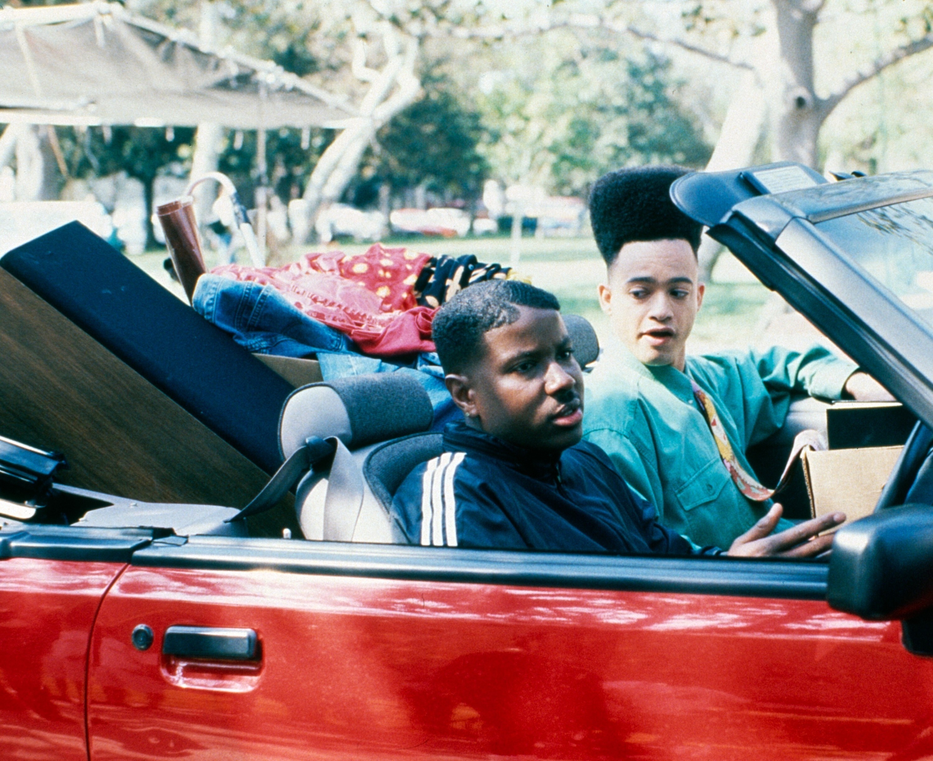 Christopher Reid and Christopher  Martin of Kid &#x27;n Play sit in a convertible during a scene from &quot;House Party&quot;