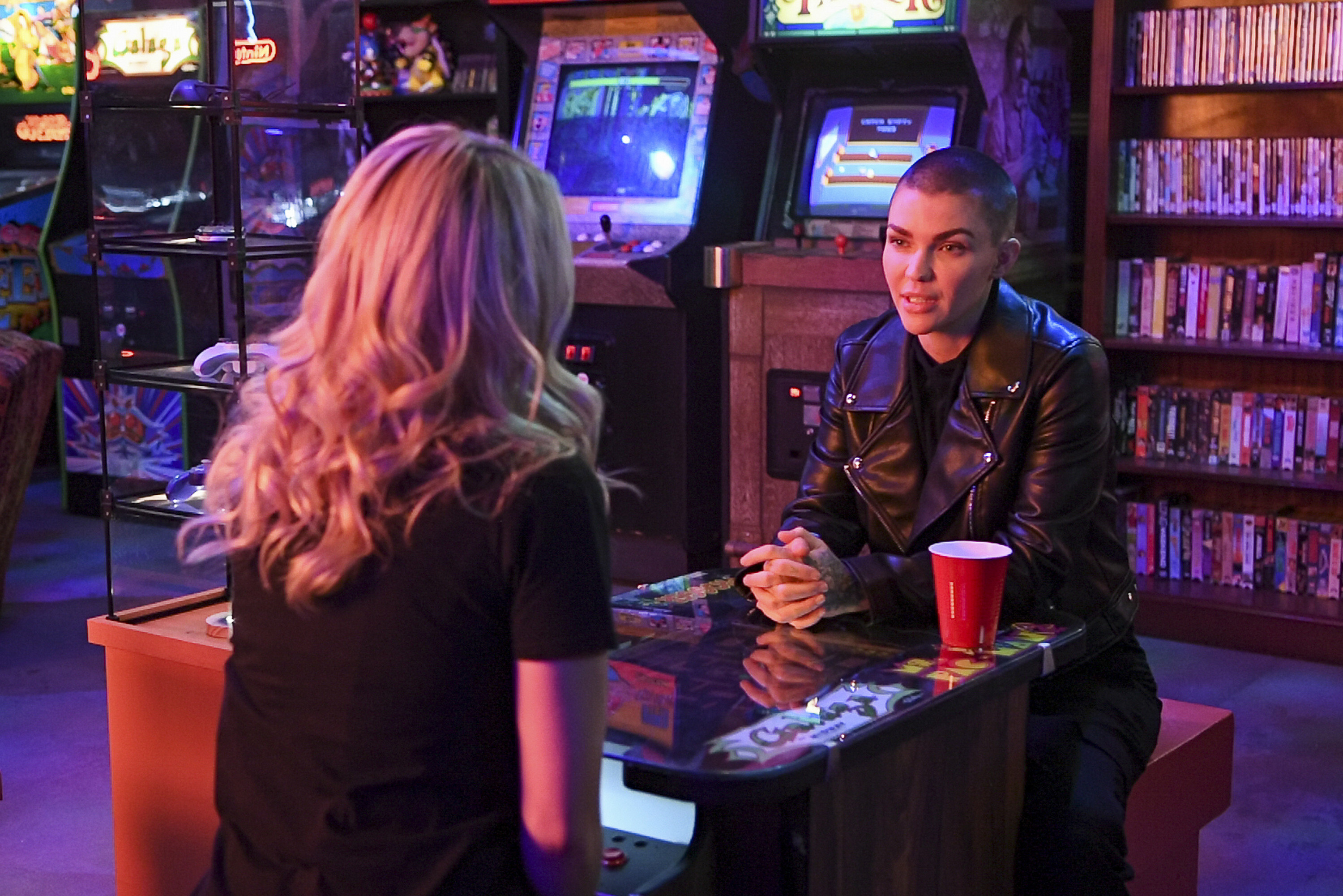 two women talk in an arcade