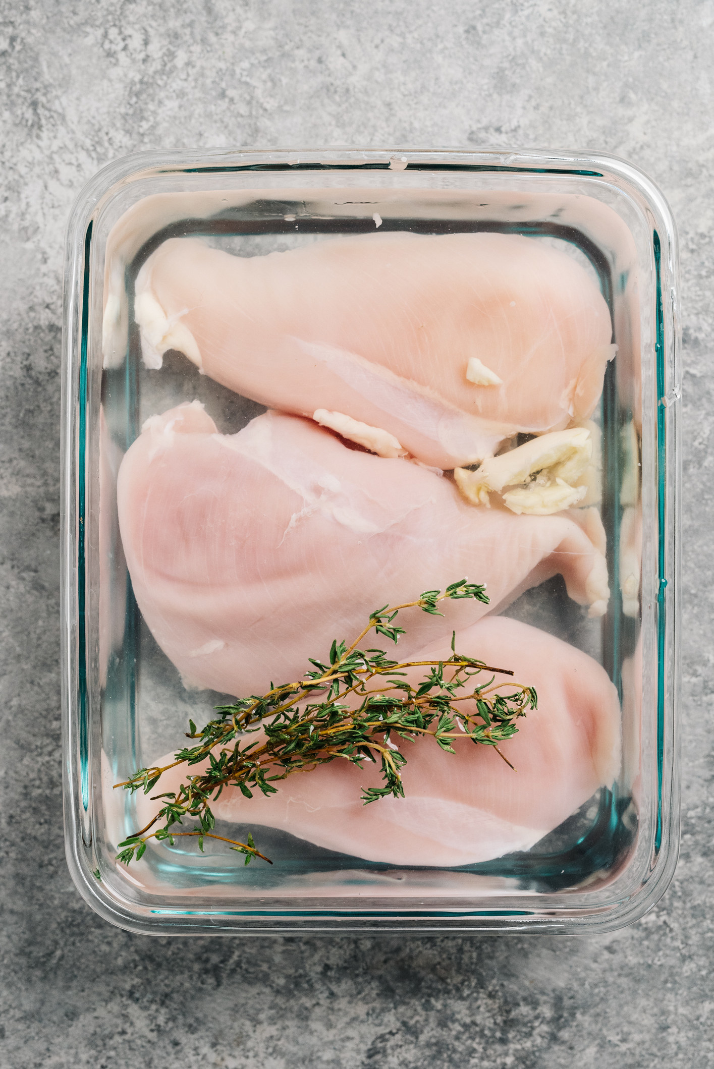 Raw chicken in a glass baking pan
