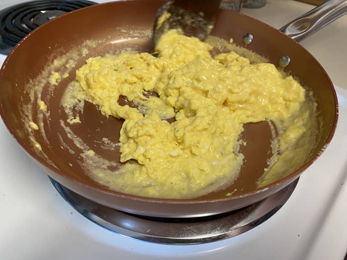 Scrambled eggs cooking in a pan