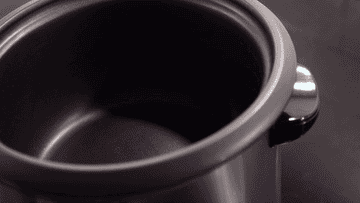 A video showing a plastic cup of rice being poured into a rice cooker