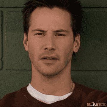 Keanu Reeves with a confused expression on his face