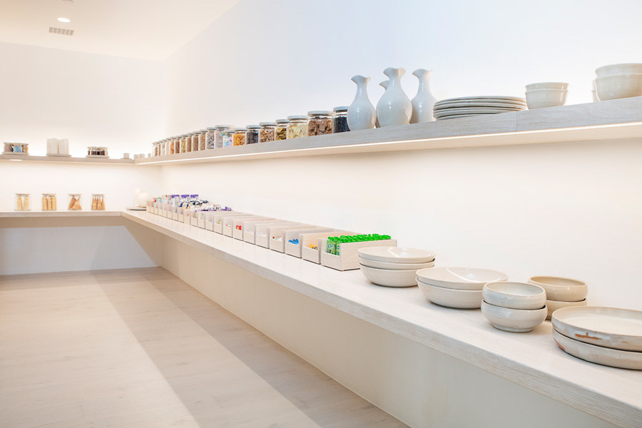 There are now two shelves; the giant glass jars remain, and they&#x27;re now joined by opened-faced bins as well as stacked plates, bowls, and cups