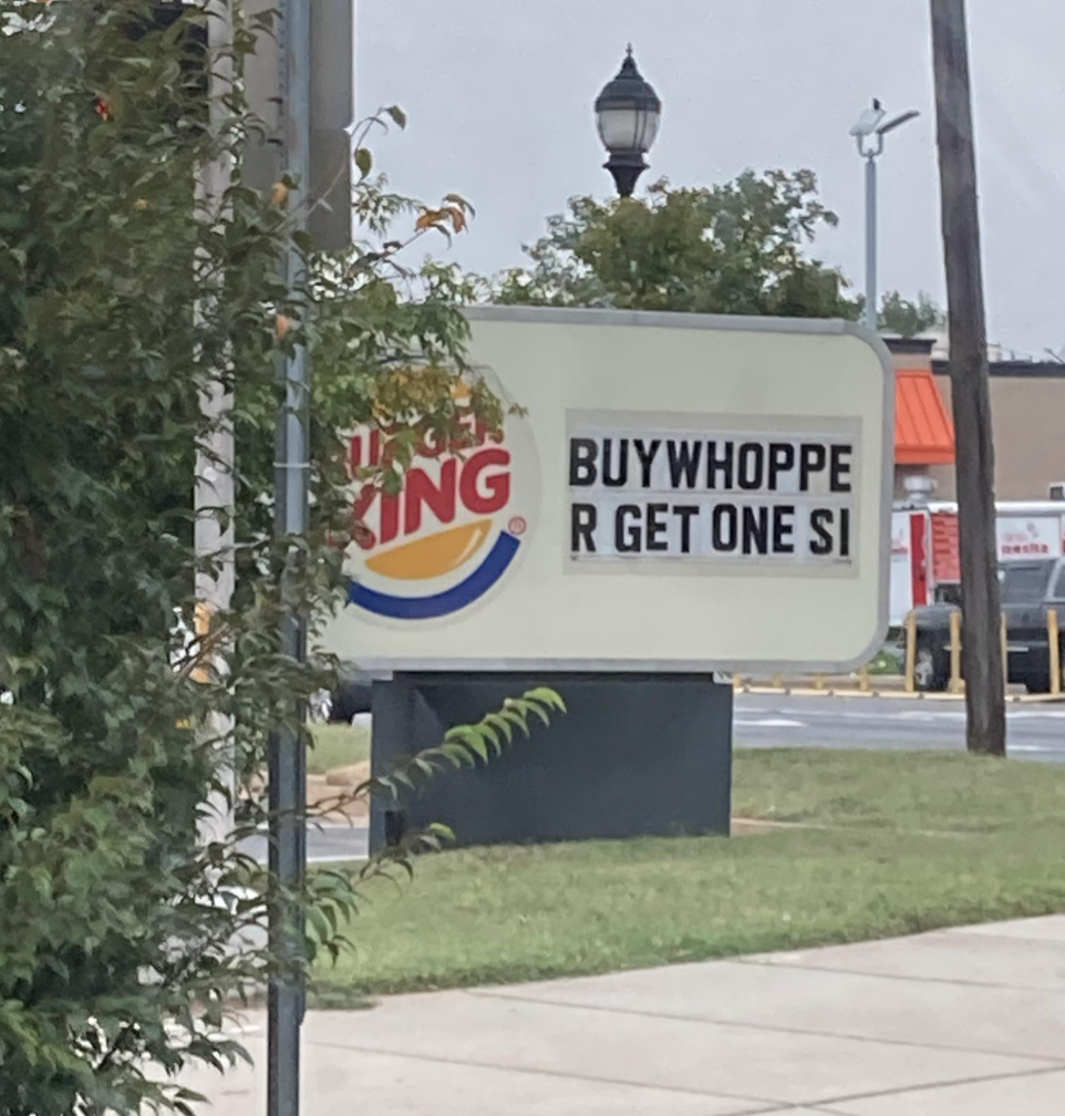 burger king sign reading buy whoppe r get one dollar