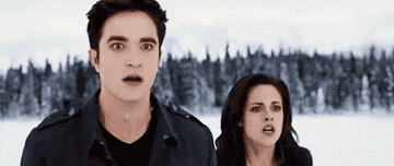 Robert Pattinson as Edward Cullen and Kristen Stewart as Bella Swan looking shocked in &quot;Twilight&quot;