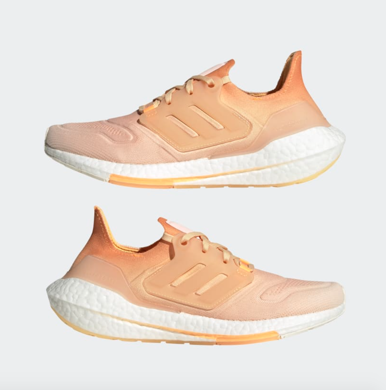 the Adidas Ultraboost 22 sneakers in a peach color
