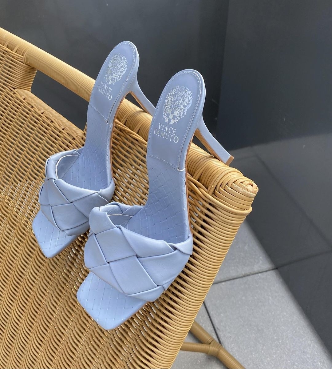 A pair of heeled sandals on the back of a patio chair