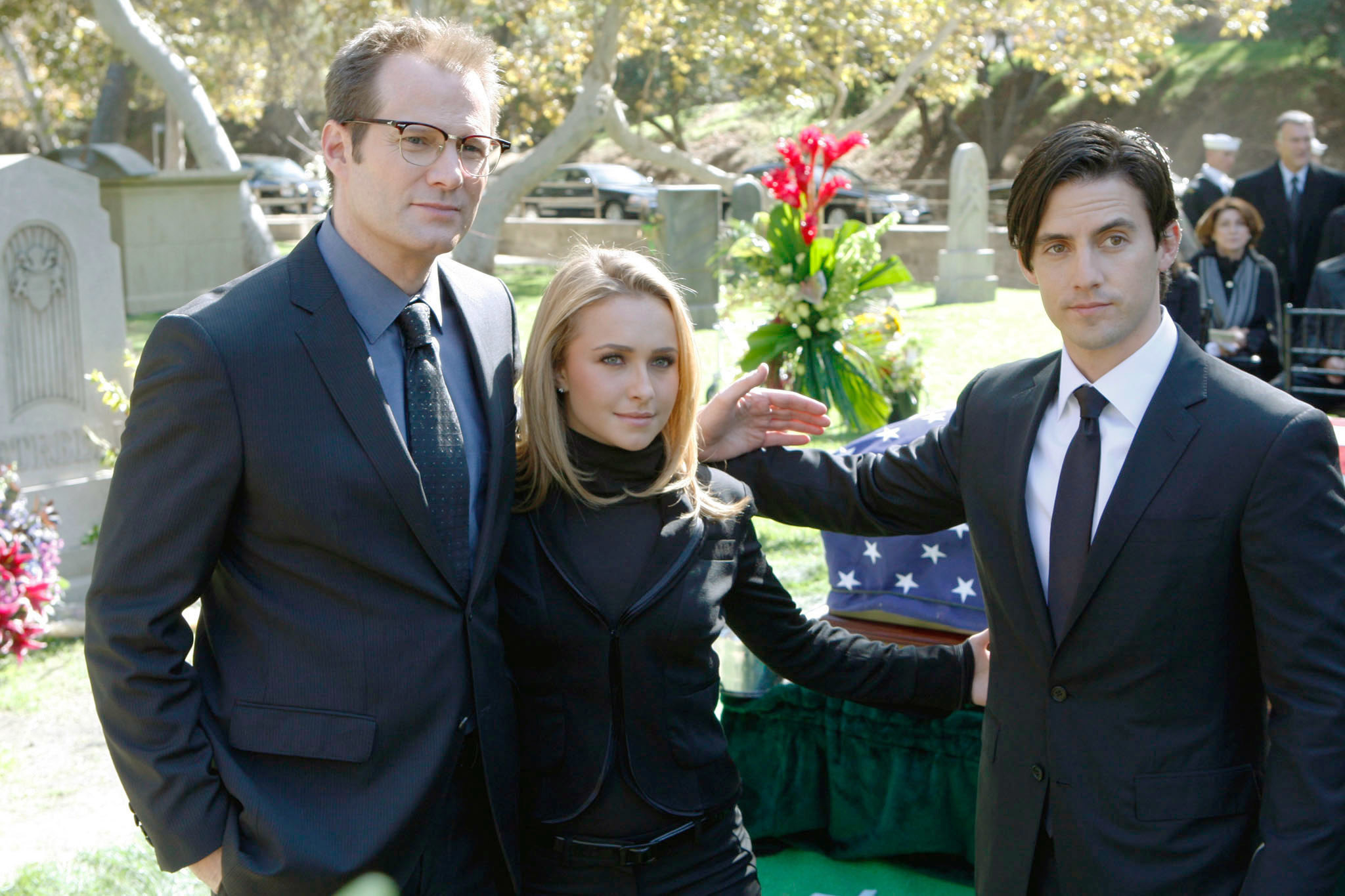 three of the characters at a funeral