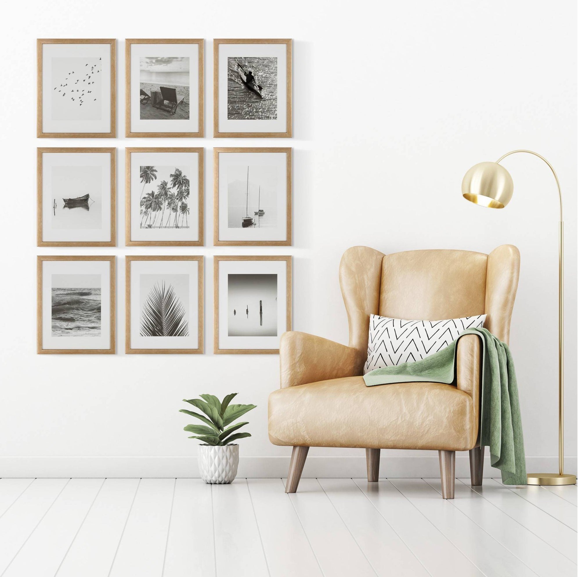 the framed prints on a white wall next to a leather chair and potted plant