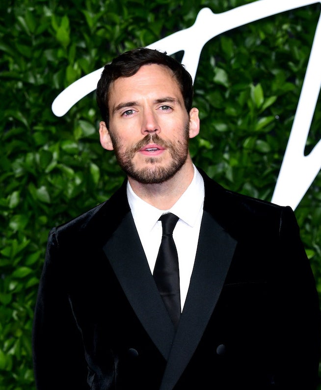 close up of Claflin in a suit and facial hair