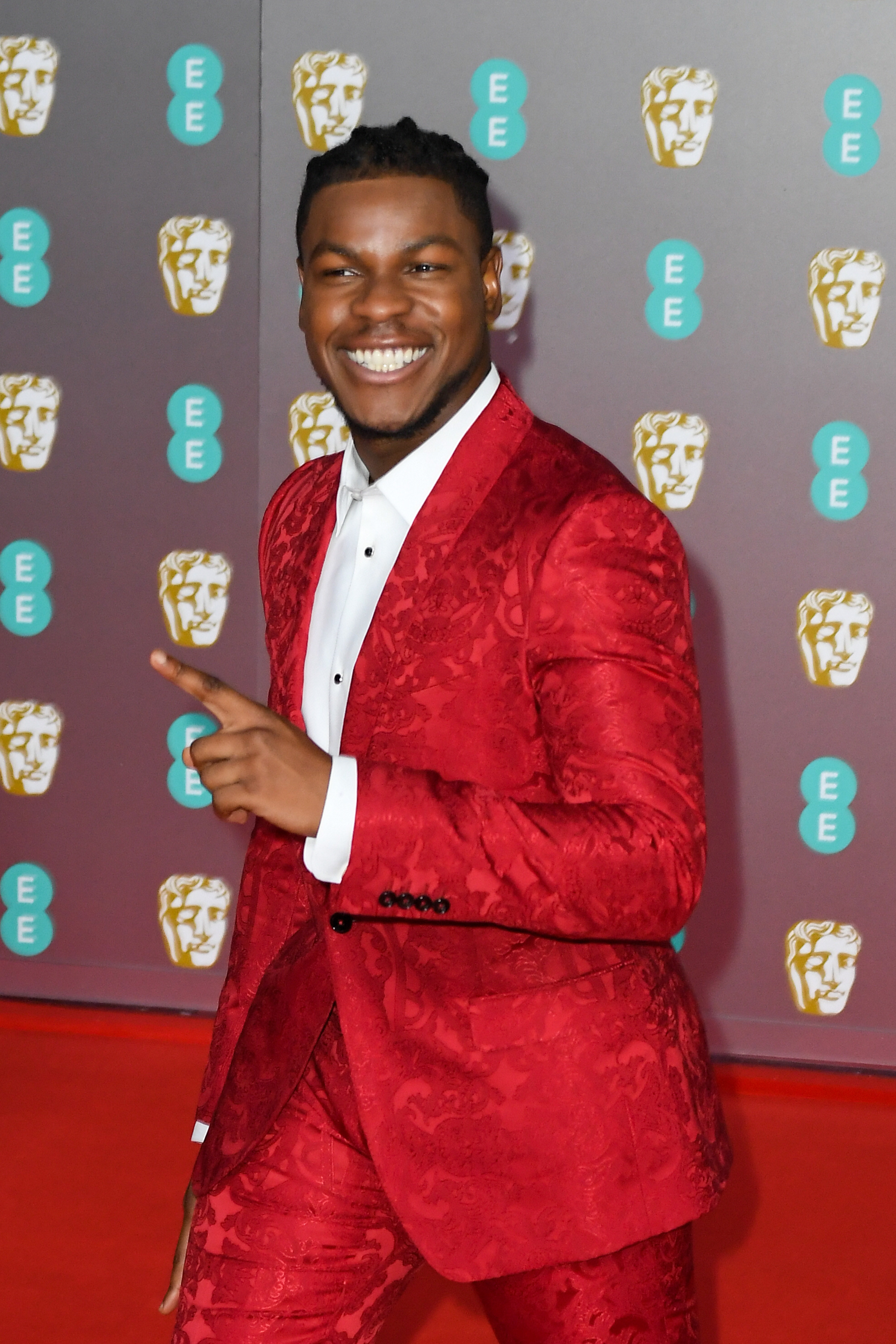 close up of Boyega on the red carpet in a suit smiling