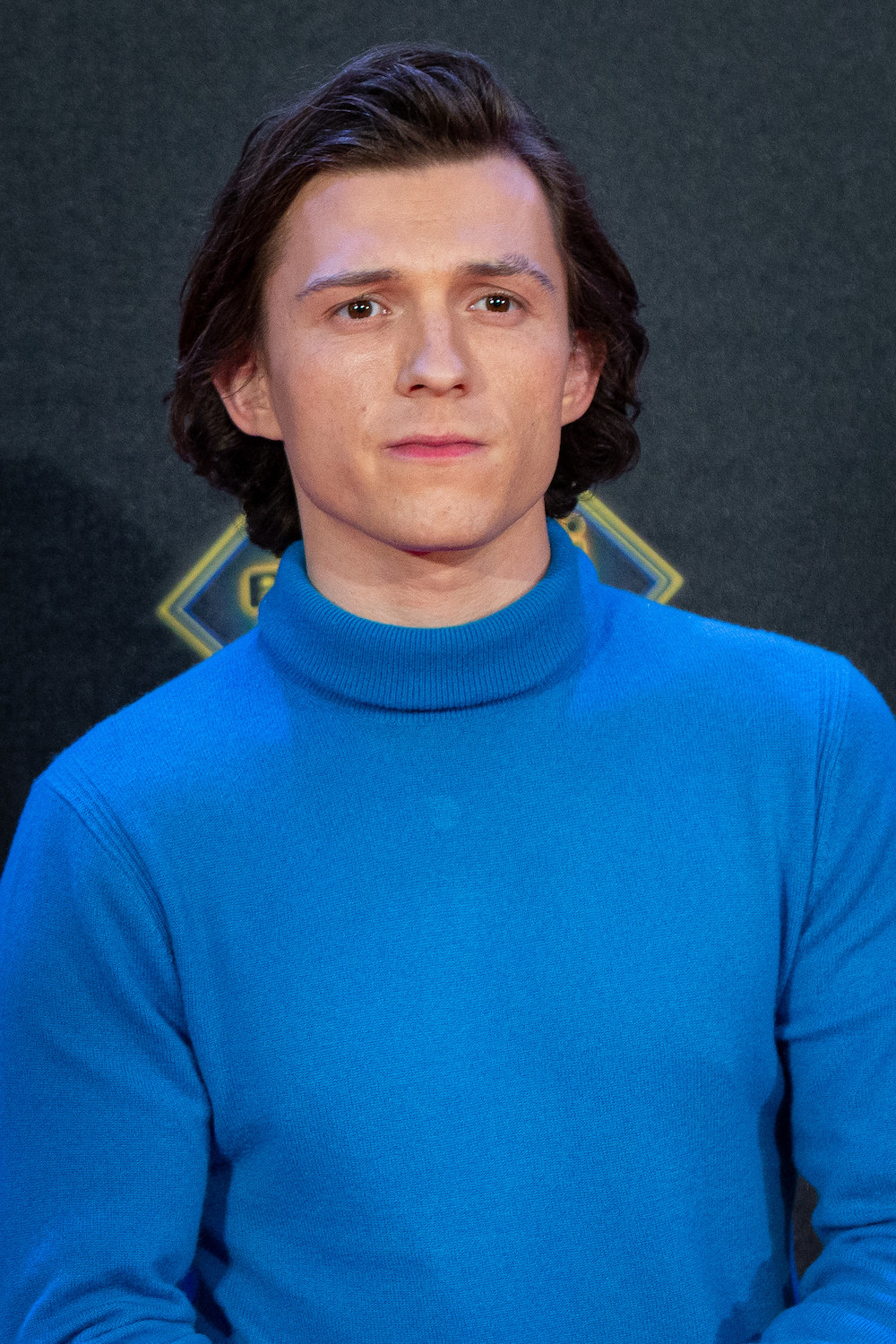 close up of Holland in a turtleneck and longer hair