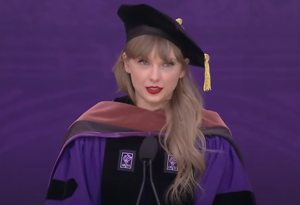 Taylor in her cap and gown giving her speech at a podium