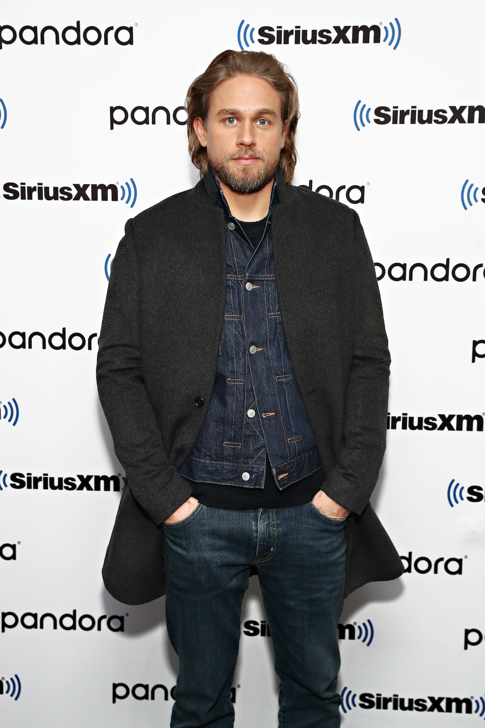 Hunnam at an event wearing a denim outfit and long hair