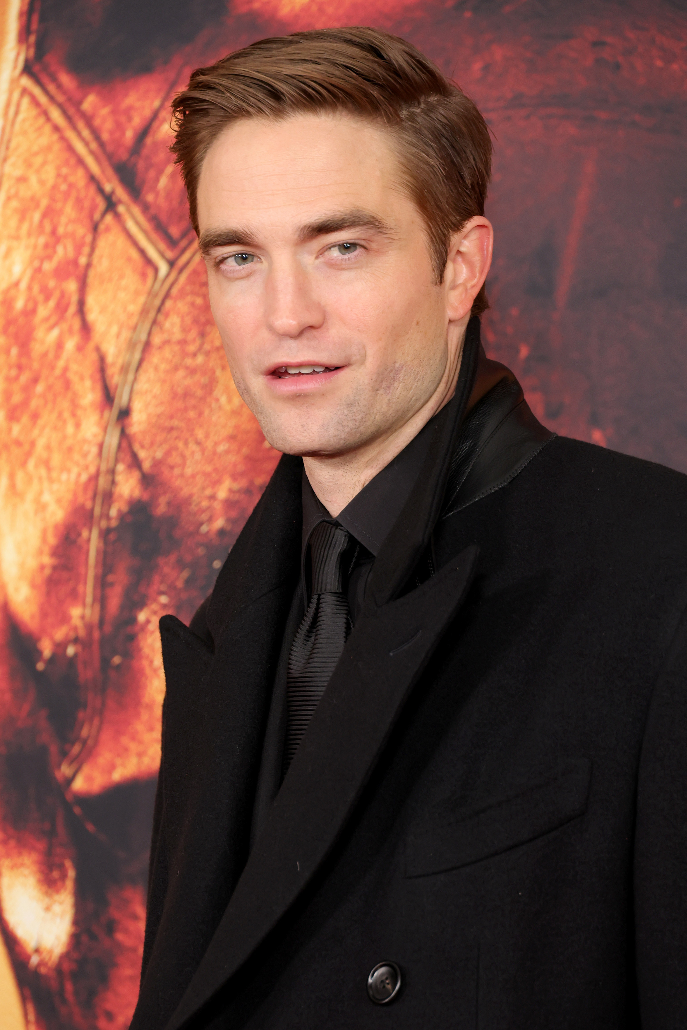 close up of Pattinson in a coat and short sleek hair