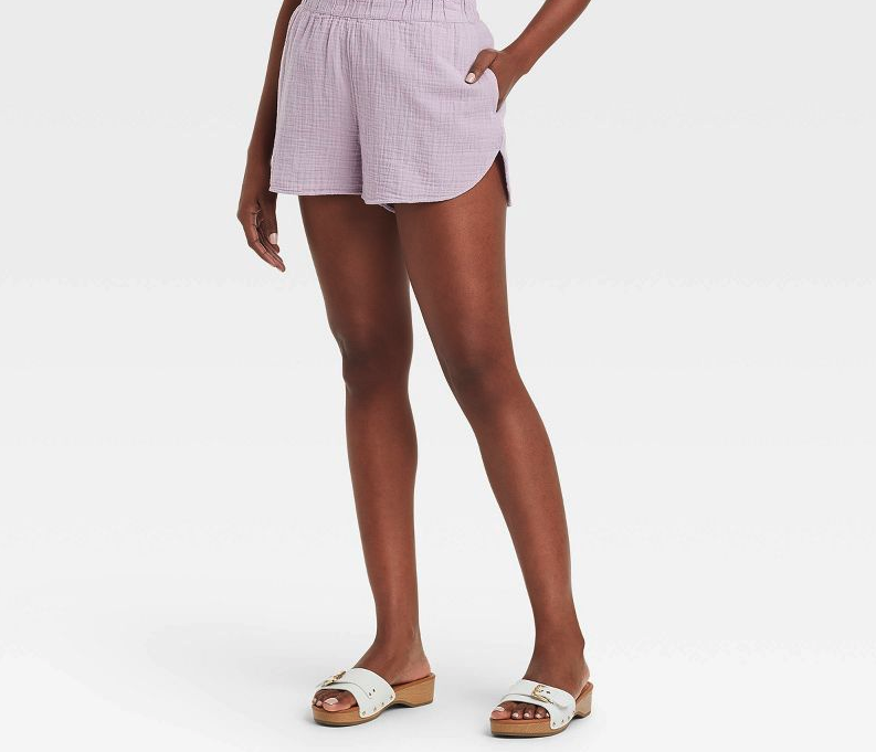 A person wearing the pull-on shorts with slide sandals