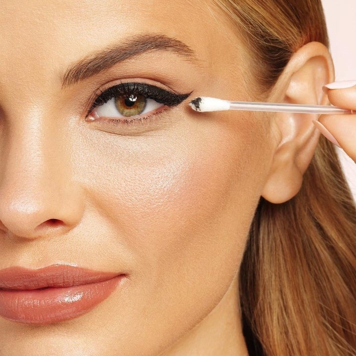 someone using the remover sticks to touch up their eyeliner