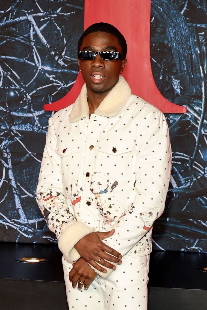 Caleb wearing a Dalmatian patterned jacket and pants with sunglasses