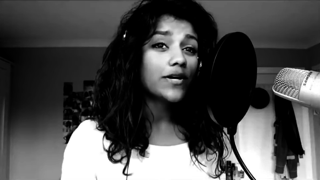 Black-and-white screenshot of Simone singing into a microphone