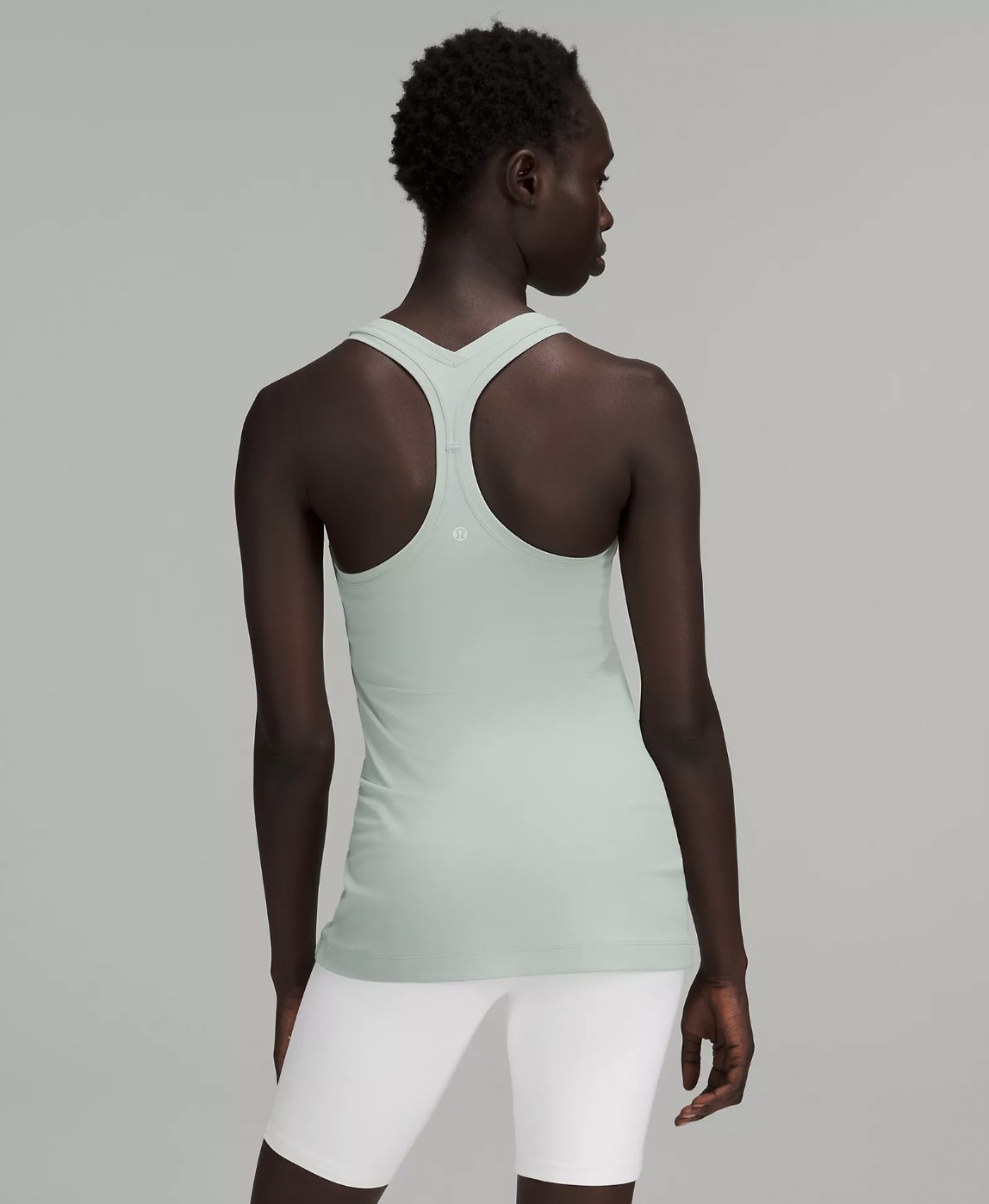 Model shown from behind in light teal racerback tank