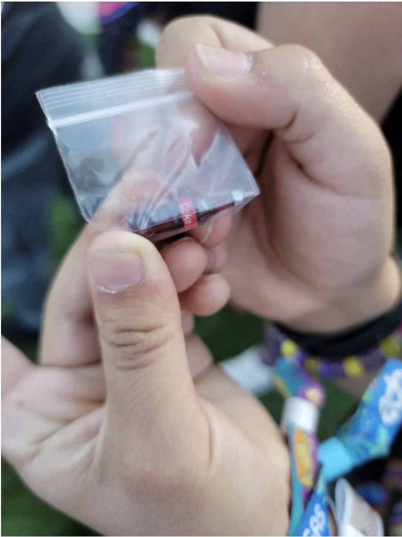 a tiny coke bottle in a tiny plastic bag