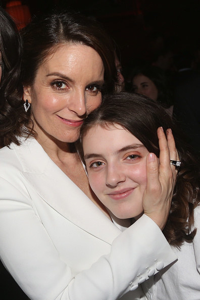 Tina and an older Alice hugging at an event