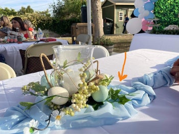 Reviewer image of light blue chiffon table runner on a white table with decorative centerpiece 