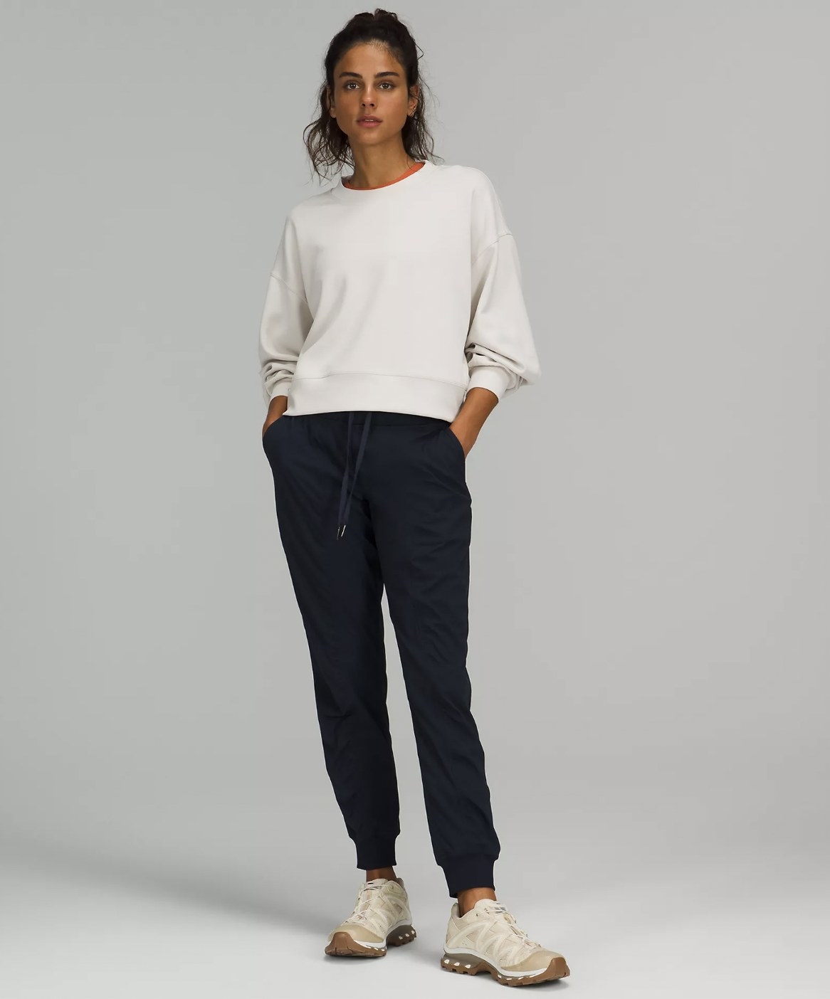 Model wearing the navy blue joggers with white crewneck sweatshirt