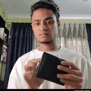 A man looks angry and shows his empty wallet.