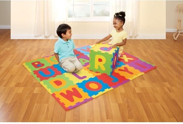 Two kids playing on foam mat