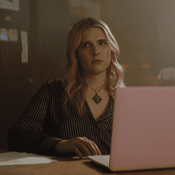 Hari Nef at a laptop in &quot;You&quot;
