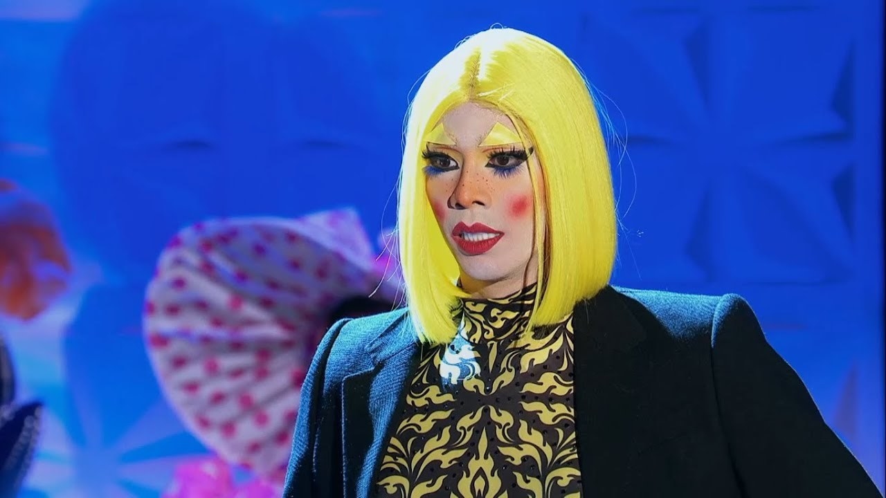 A drag queen looking shocked
