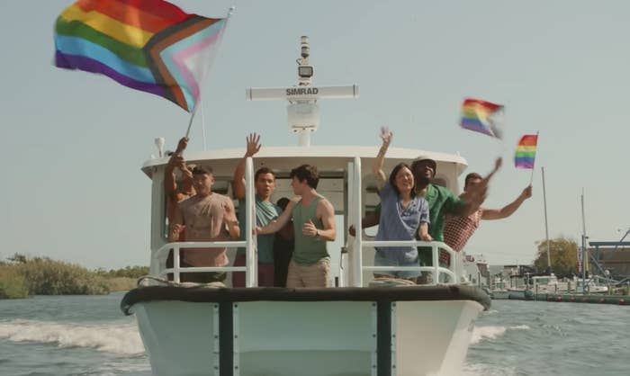 Several characters wave Pride flags on a boat