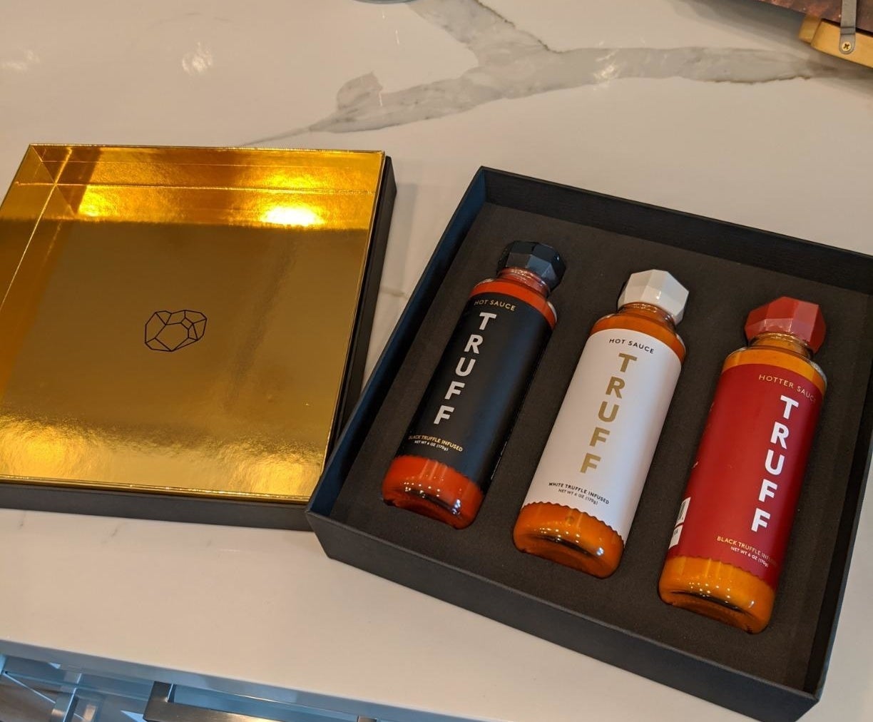 a reviewer&#x27;s image of the hot sauce set in its packaging