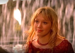 Lizzie McGuire is standing in front of a waterfall