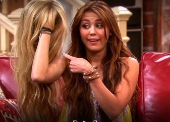 Miley Stewart is holding up a blonde wig