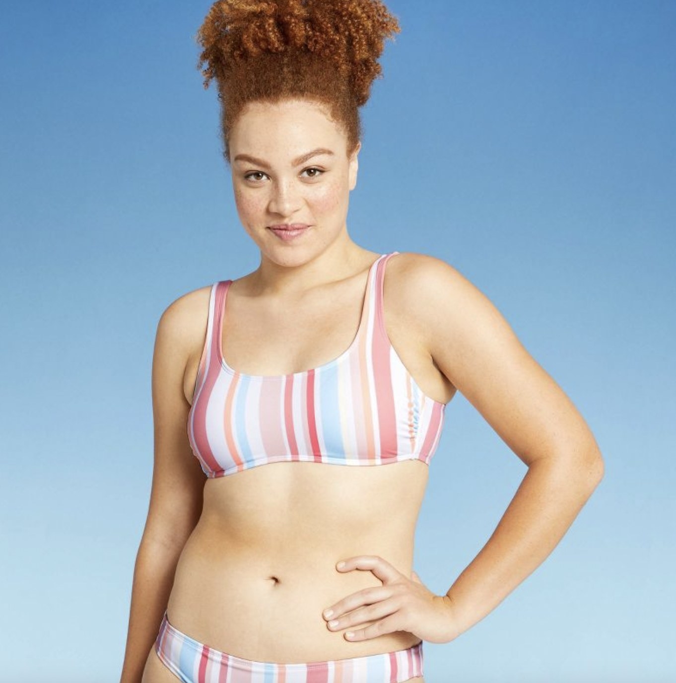 A person wearing a multi-stripe bikini top and matching bottom