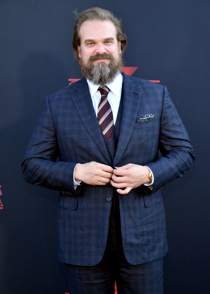 David in a suit and larger beard and hair combo