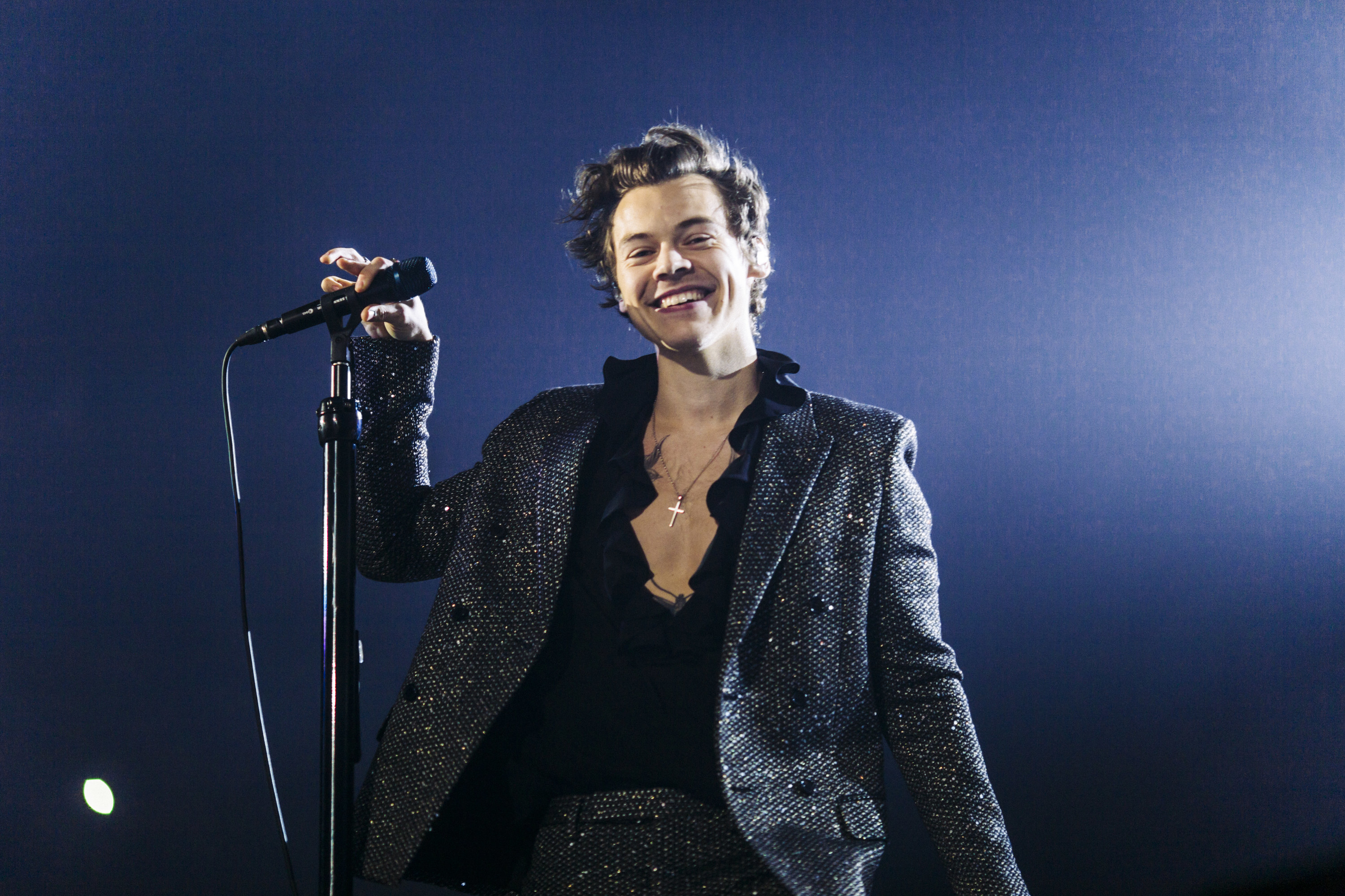 A closeup of Harry performing on stage