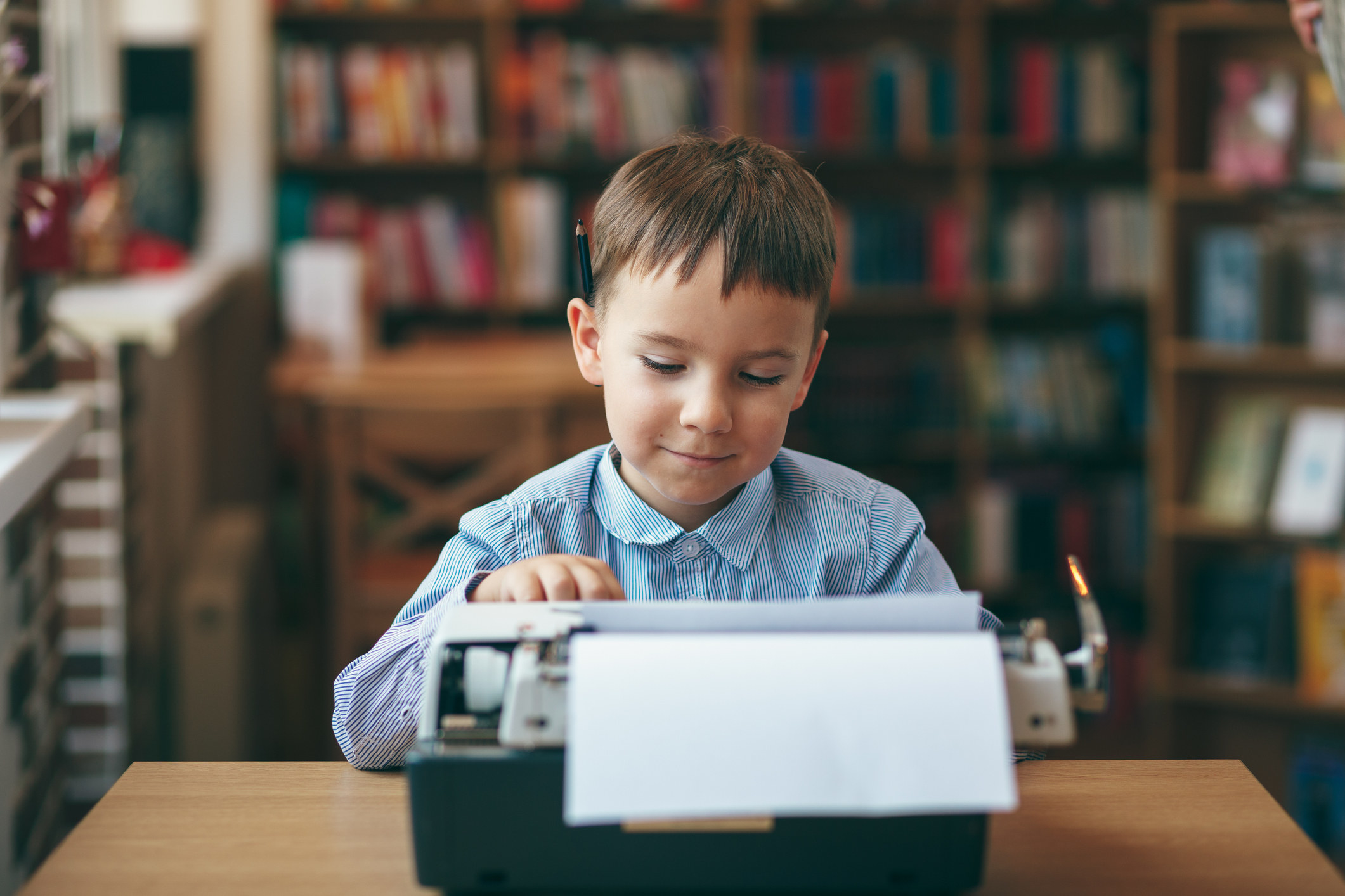 young boy using a typewriter