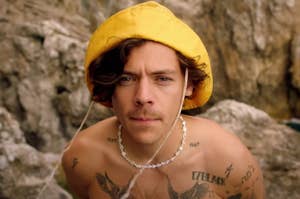 Harry Styles staring intensely ahead in the Golden music video