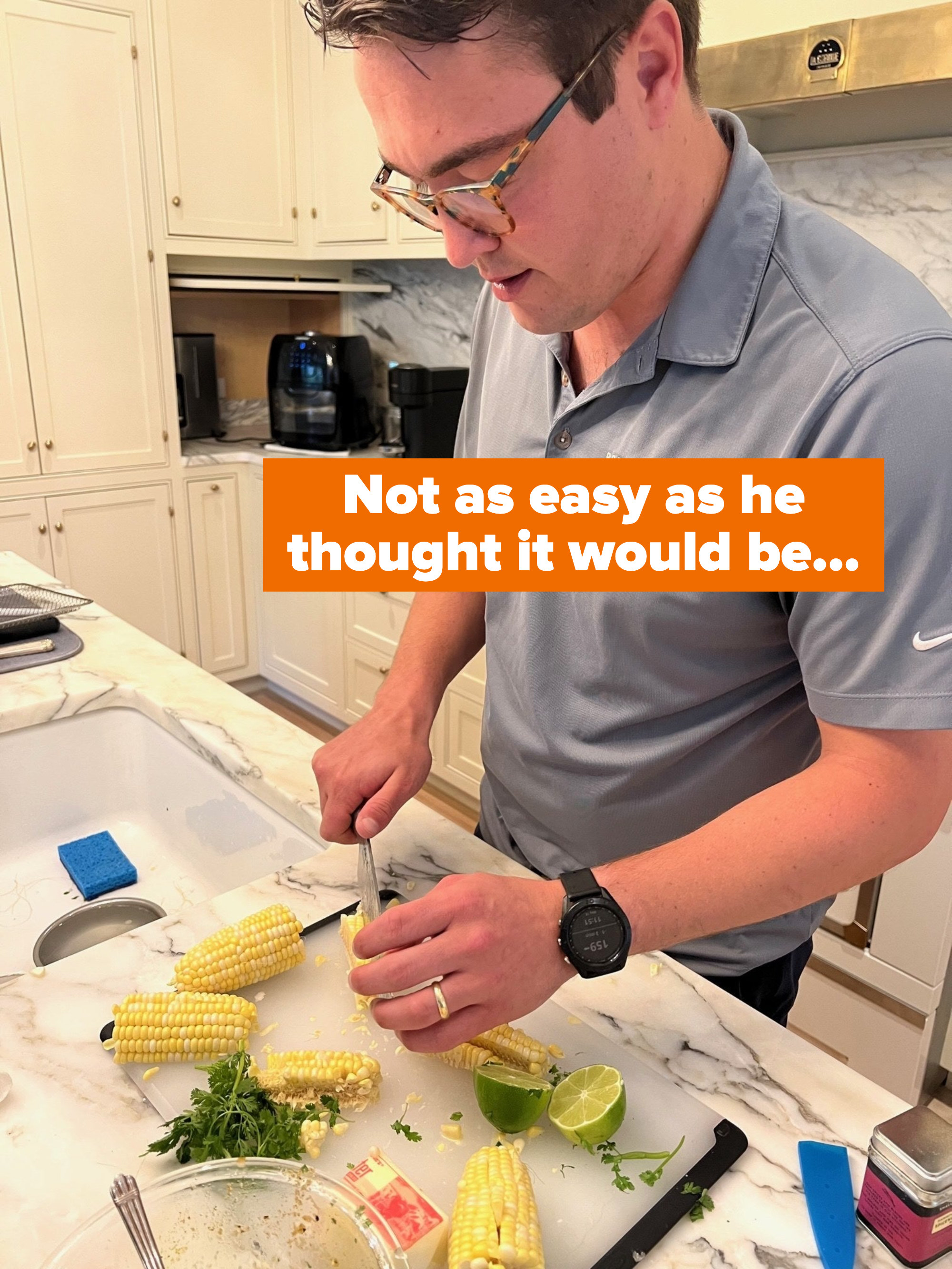 A man cutting corn on the cob