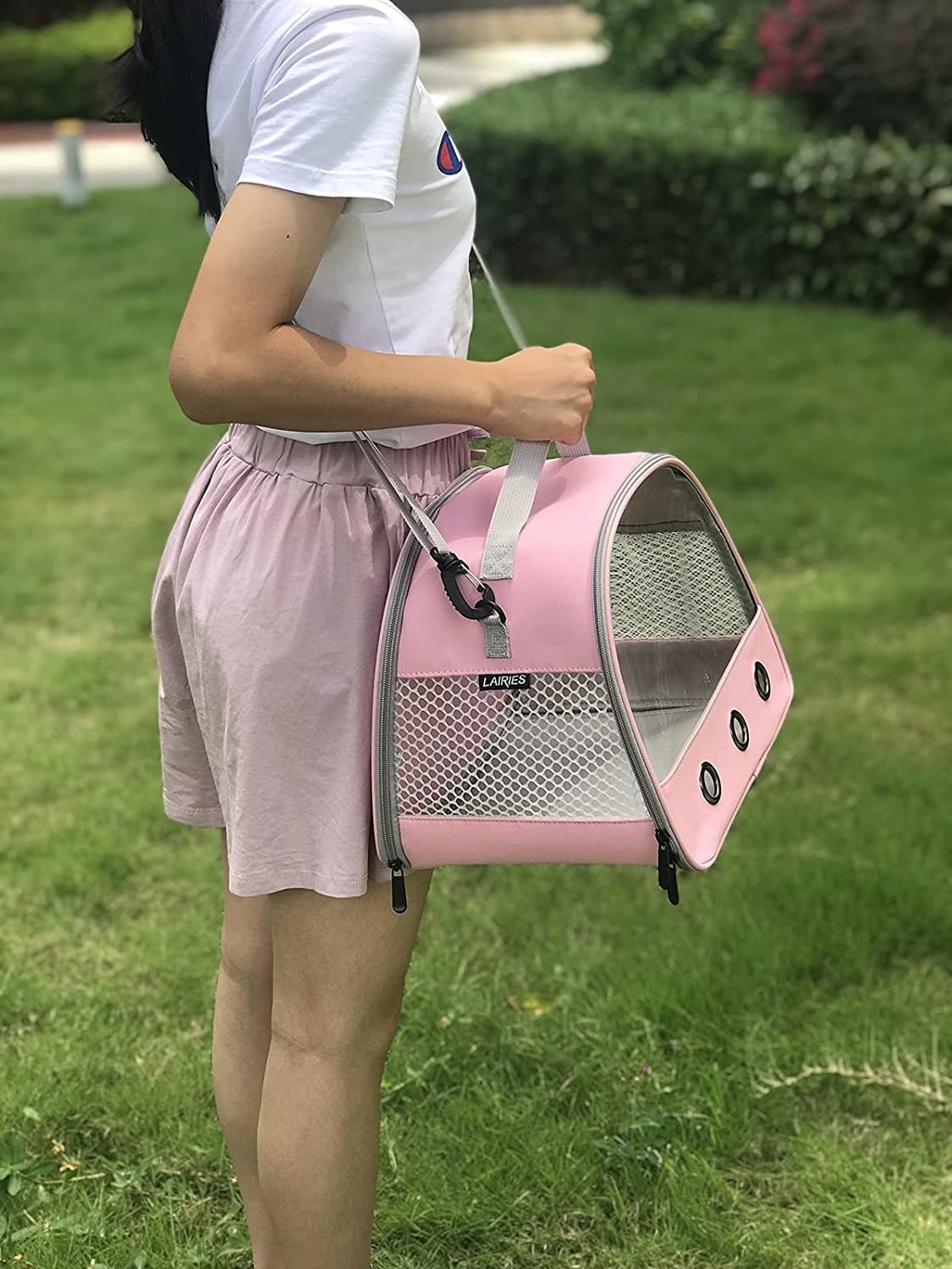 Someone wearing the carrier while standing in the grass