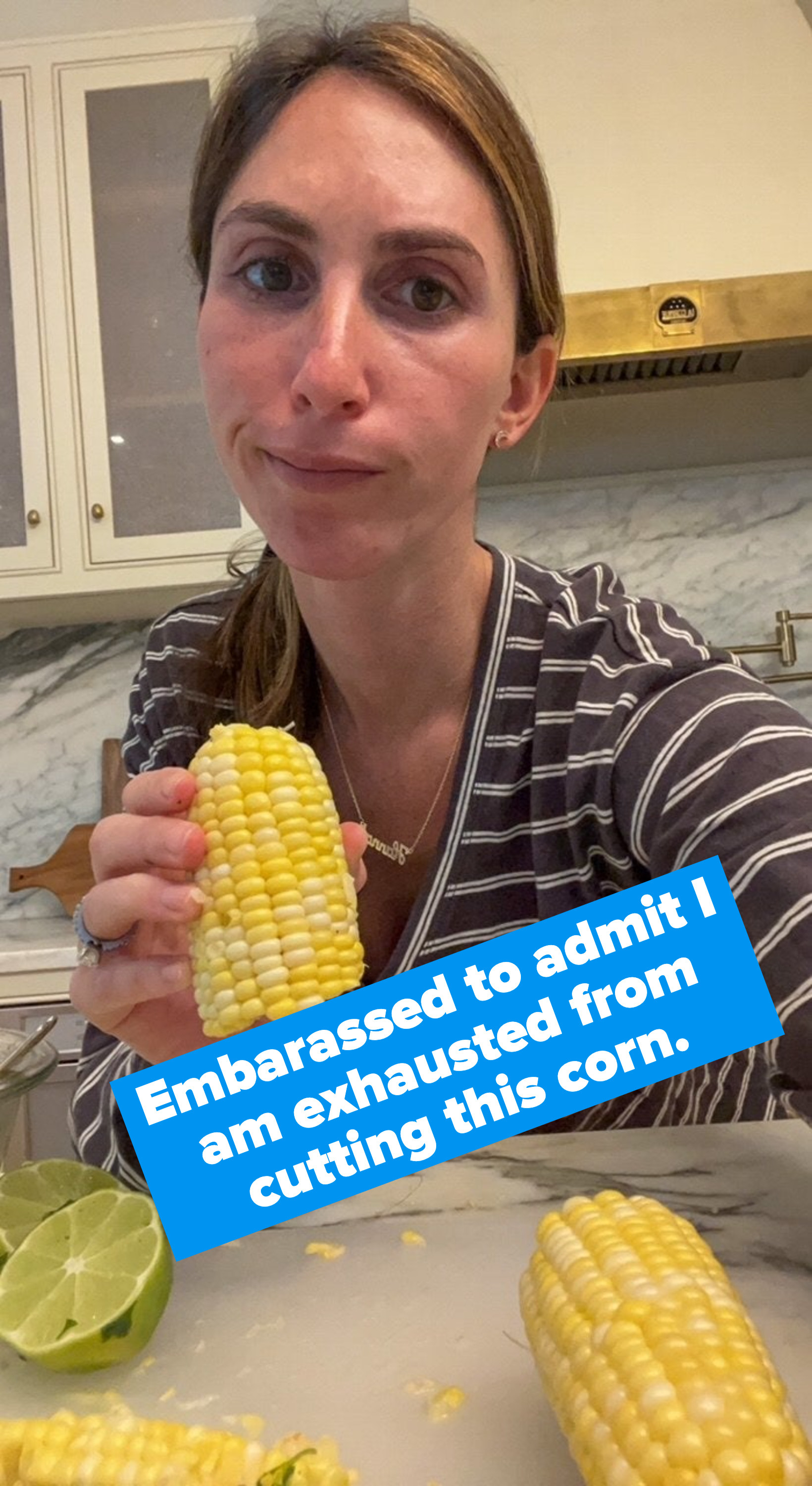 A woman holding a piece of corn