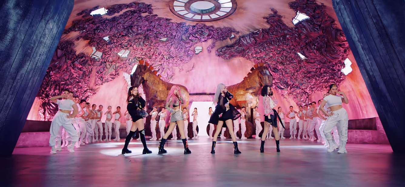 the group dancing in front of backup dancers in the video