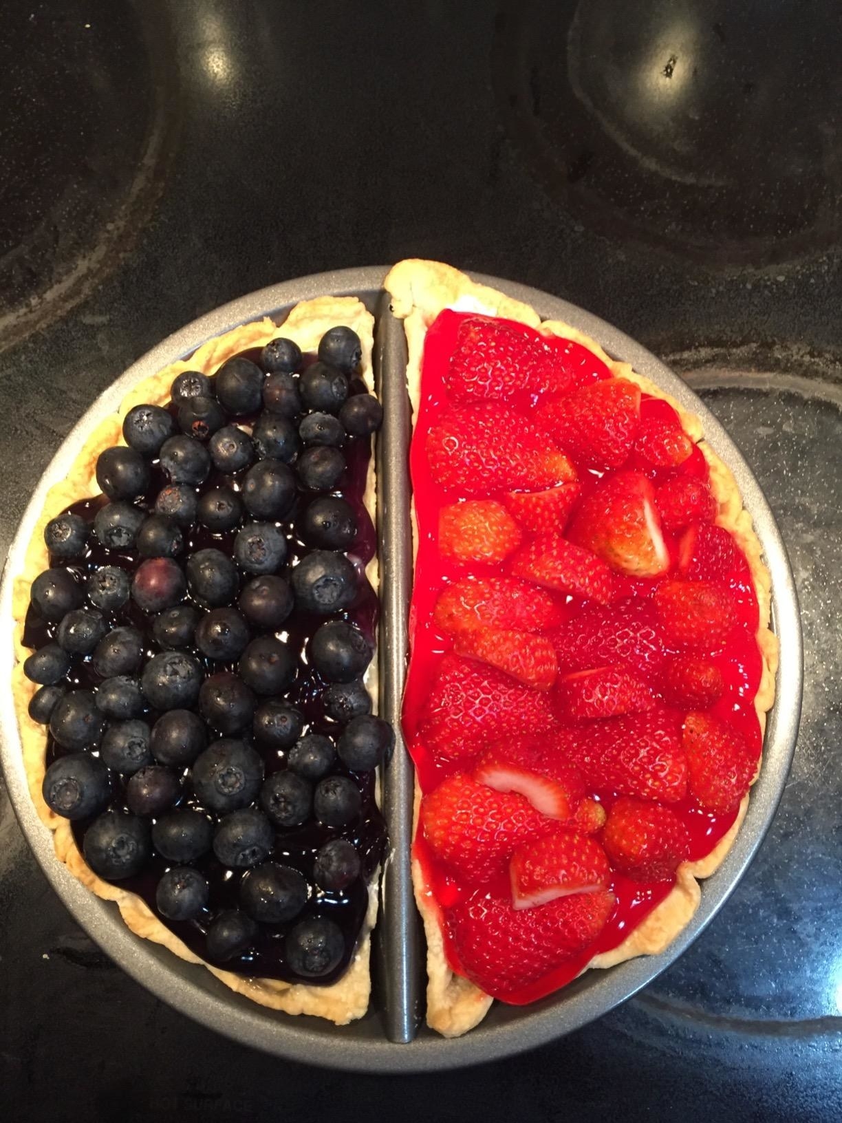 reviewer&#x27;s pie pan with blueberry on one half and strawberry on the other