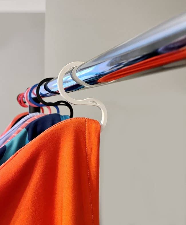 hoodies hanging on the hooks, which look like half hangers