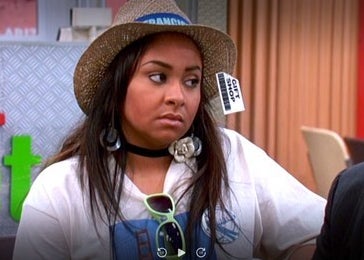 Raven Baxter wearing a hat with the price tag still on 