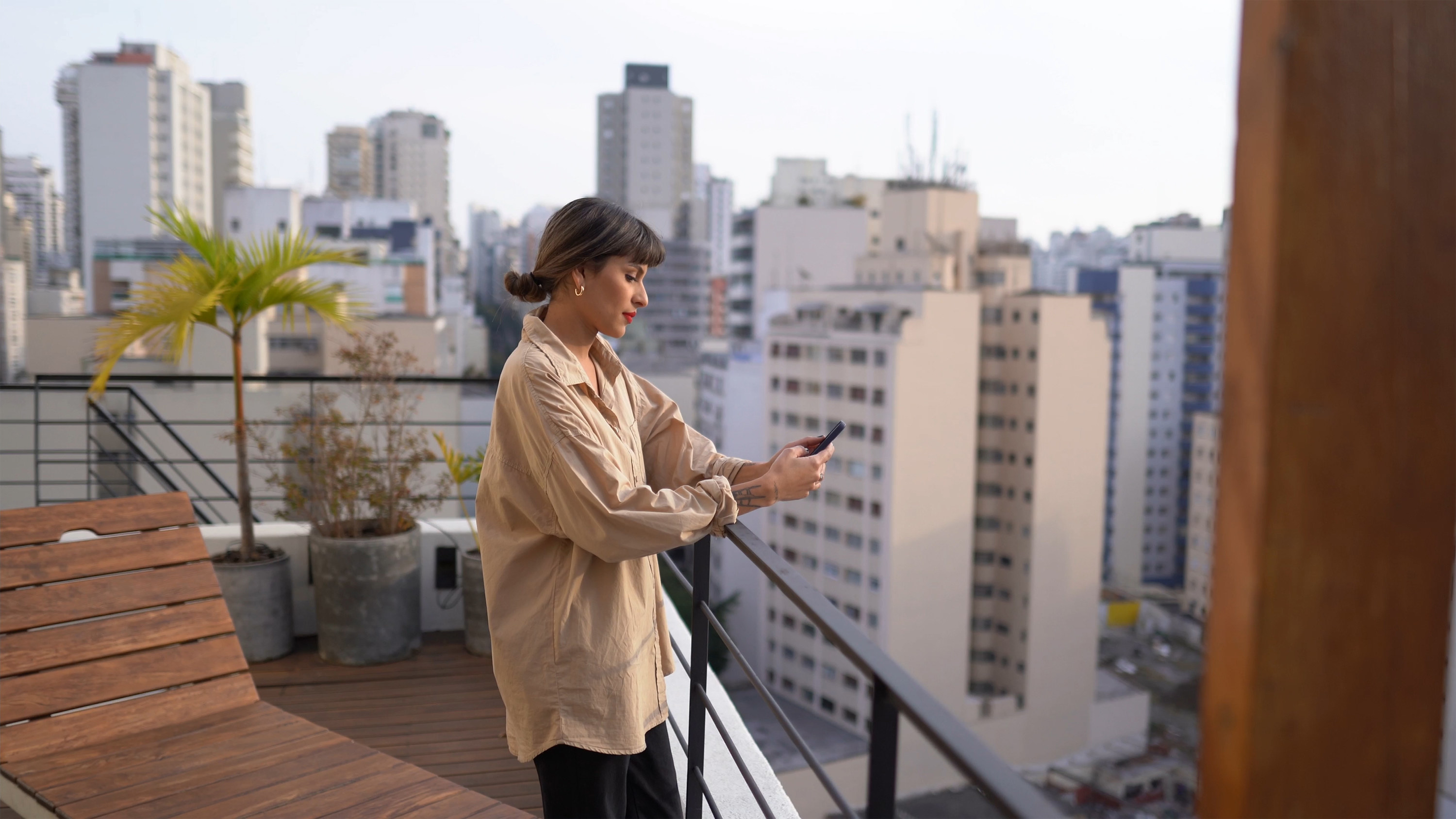 A woman on the balcony with her phone